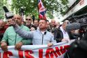 Tommy Robinson (centre), whose real name is Stephen Yaxley Lennon, leads a protest march through London to Parliament Square where speeches will take place and a film will be shown. Groups from across the UK linked to football disorder are expected to