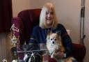 Maureen Martin, formerly a Norwich Ladies FC and England footballer, relaxing with her dog. With her are a few trophies and her England cap. Picture: DENISE BRADLEY