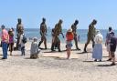 Delighting crowds at the First Light Festival and all summer - the five striking 8ft (2.4m) Walking Men bronze figures on South Beach in Lowestoft. Picture: Mick Howes