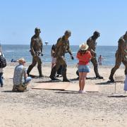 Delighting crowds at the First Light Festival and all summer - the five striking 8ft (2.4m) Walking Men bronze figures on South Beach in Lowestoft. Picture: Mick Howes