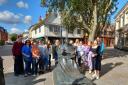 Young people at the Thomas Wolsey statue in Ipswich town centre.