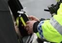 A police officer looking at a breathalyser (Liam McBurney/PA)