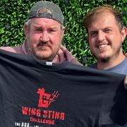 Owner of Jus' Winging It Joe Pybus (right) with the first winner of the 'Wing Sting' challenge Damien