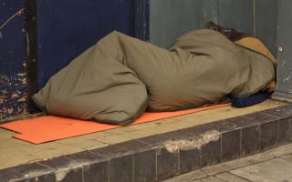 A homeless person sleeping in a doorway. Photo: Getty Images