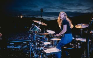 Grace Ellis on stage in front of a crowd of 35,000 playing drums with The Killers at Carrow Road in 2022. Picture: Rob Loud