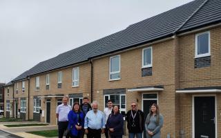 The six new homes are unveiled in Lowestoft. L-R: Richard Mays (Hyams), Kirsty Ayers (ESC), James Hick (Homes England), Cllr David Beavan (ESC), Kieran Bleasby (Orwell), Cllr Janet Craig (ESC), Cllr Keith Patience (ESC) and Lucy (Milton Road East