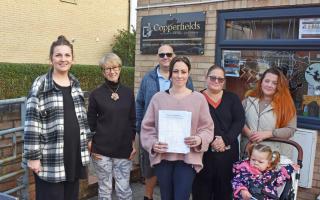 Shoppers with Kayley Morgan, and the petition, at the Copperfields village store in Blundeston following the removal of the InPost parcel locker. Picture: Mick Howes